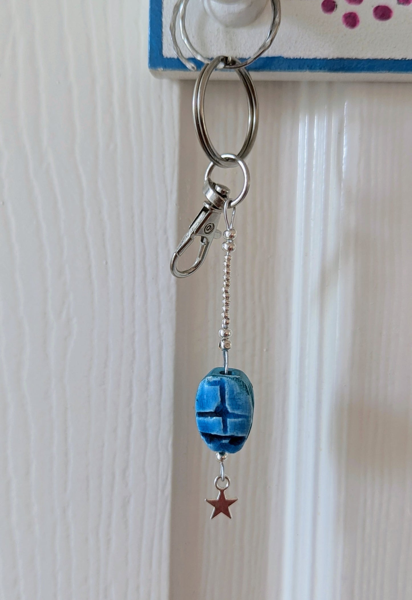 scarab keyring on silver, hanging