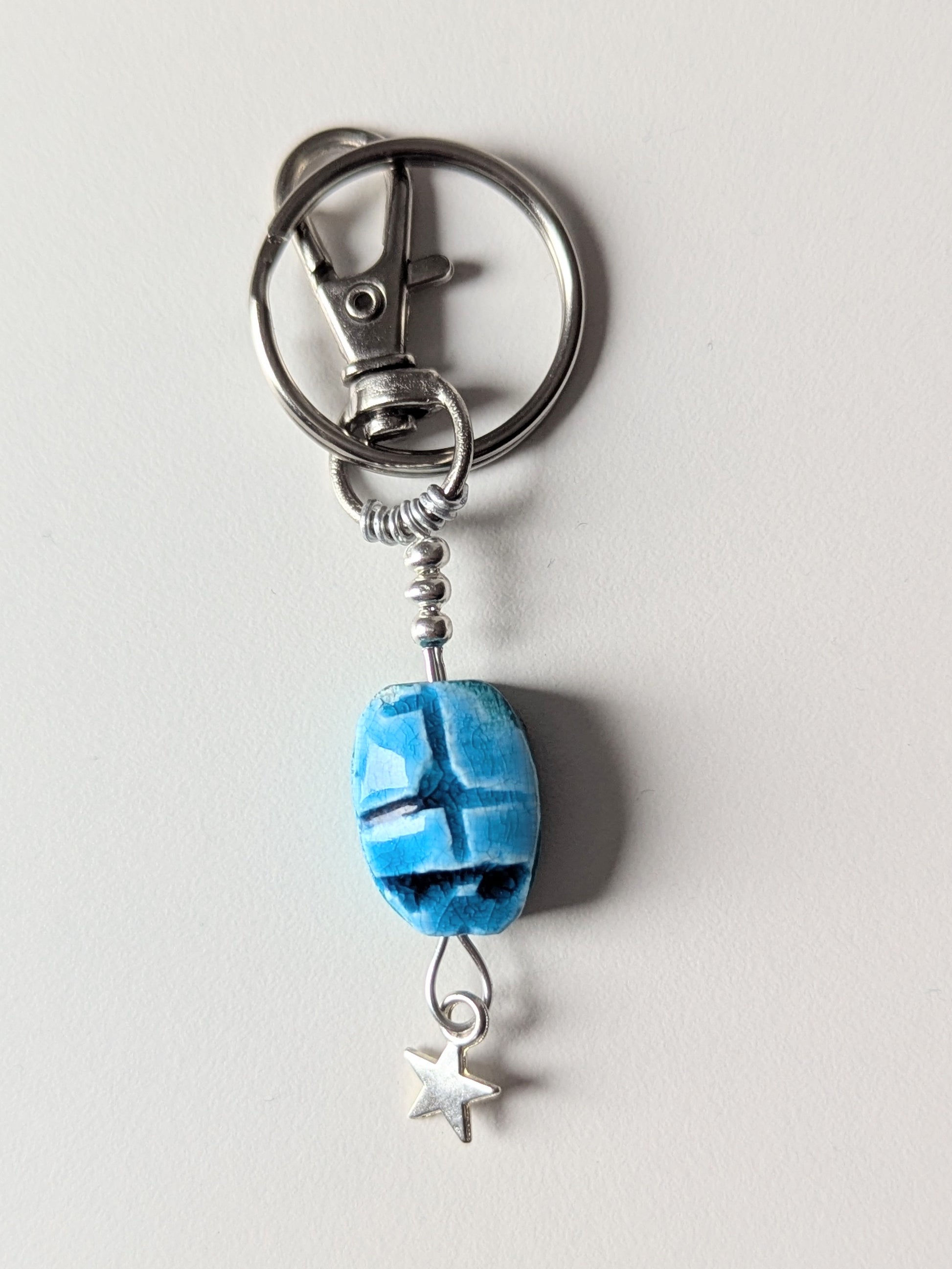 blue scarab on a silver wire keyring with sterling silver star